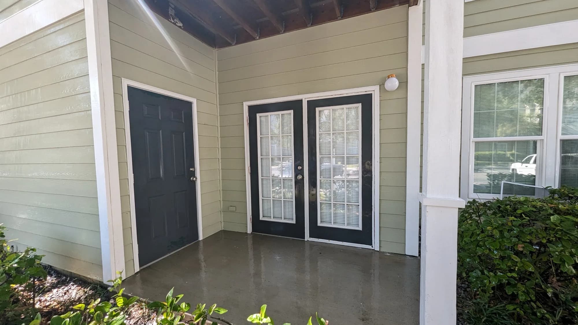 The same screened patio with clean bright concrete after washing
