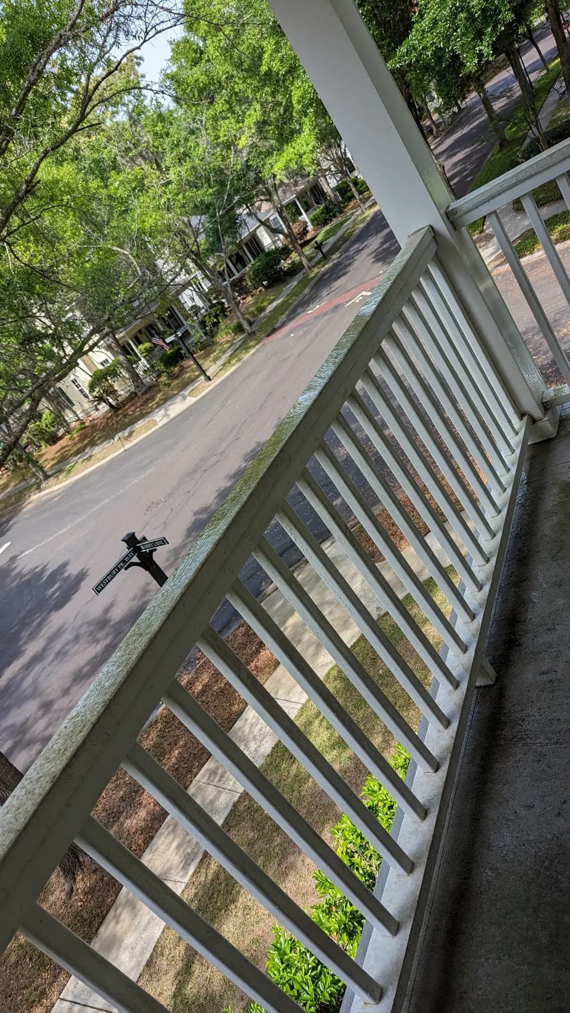 White porch railing freshly cleaned after washing